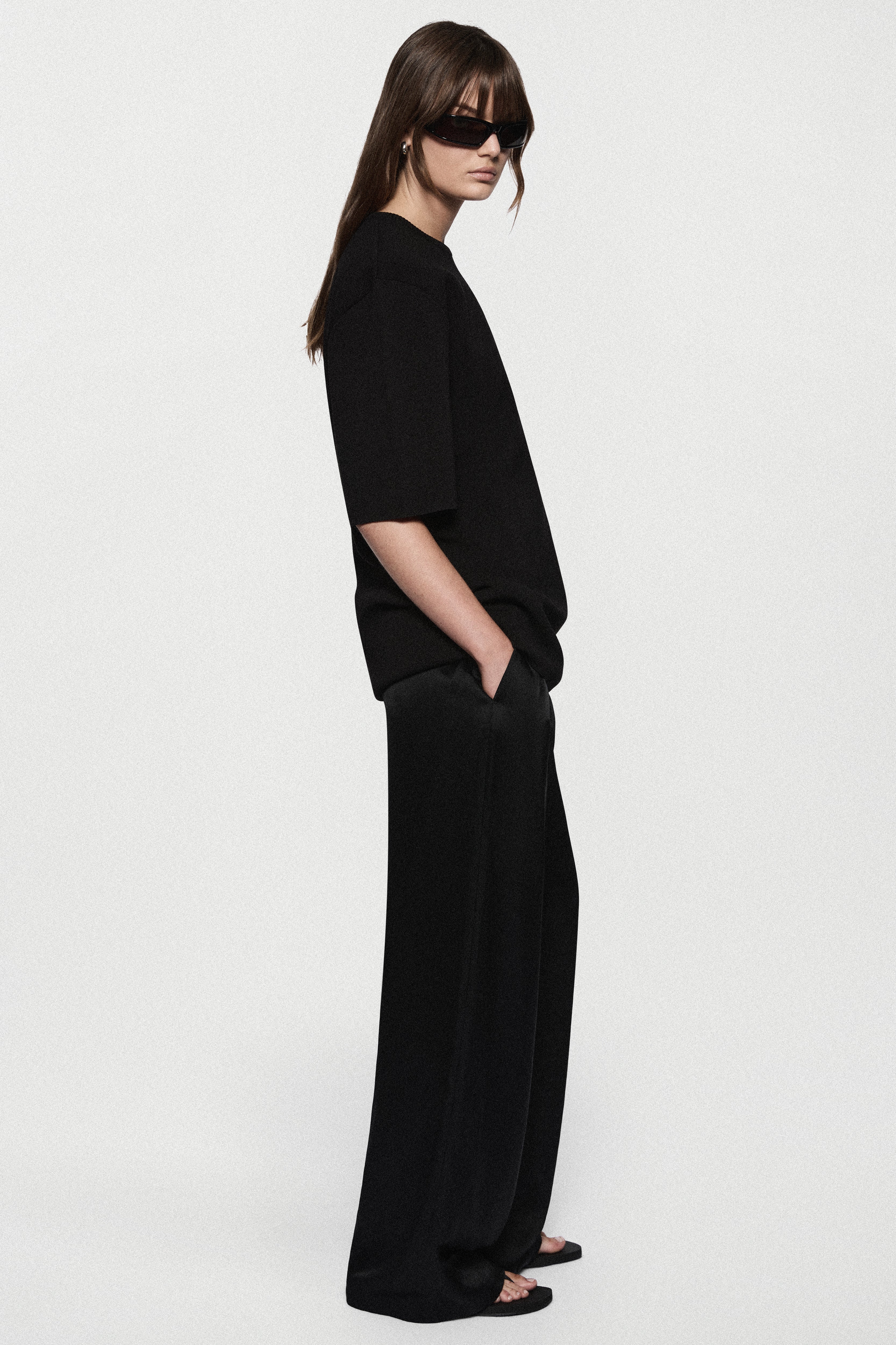 Black oversized knit tee in relaxed side profile with short sleeves