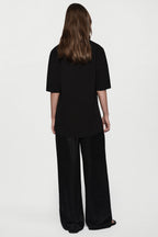 Black oversized knit tee, back view, short sleeves and crew neckline