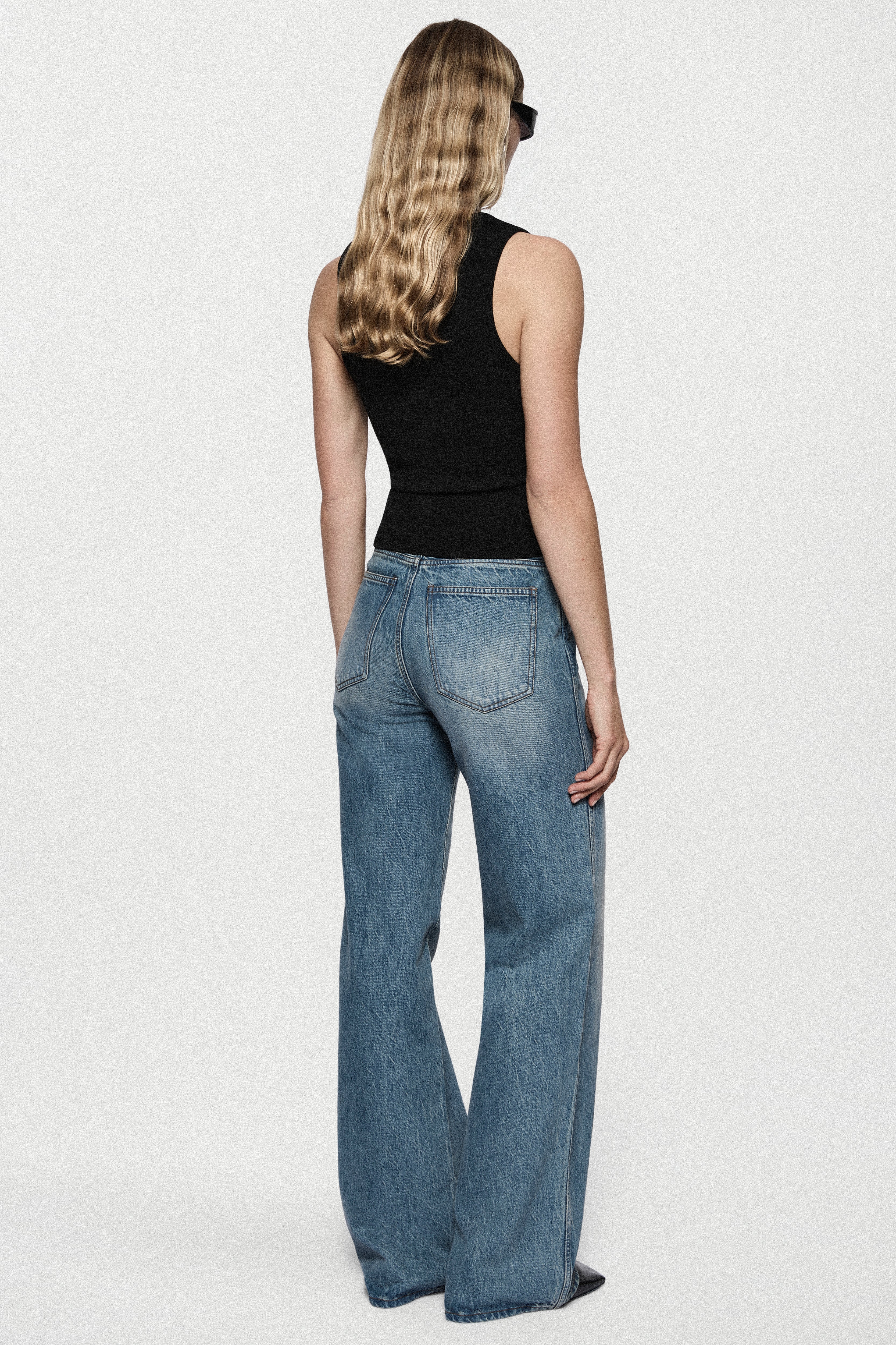 Black ribbed sleeveless tank top, back view