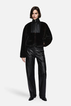 Black faux fur zip jacket with stand collar and oversized sleeves