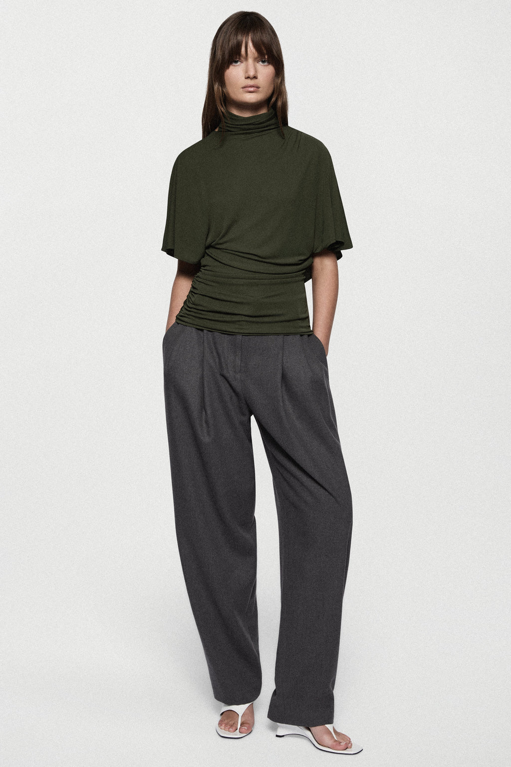 Hunter green cape jersey turtleneck top, short sleeves, ruched front.