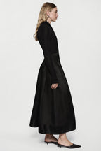 Black long-sleeve twist jersey top, side view, fitted waist seam