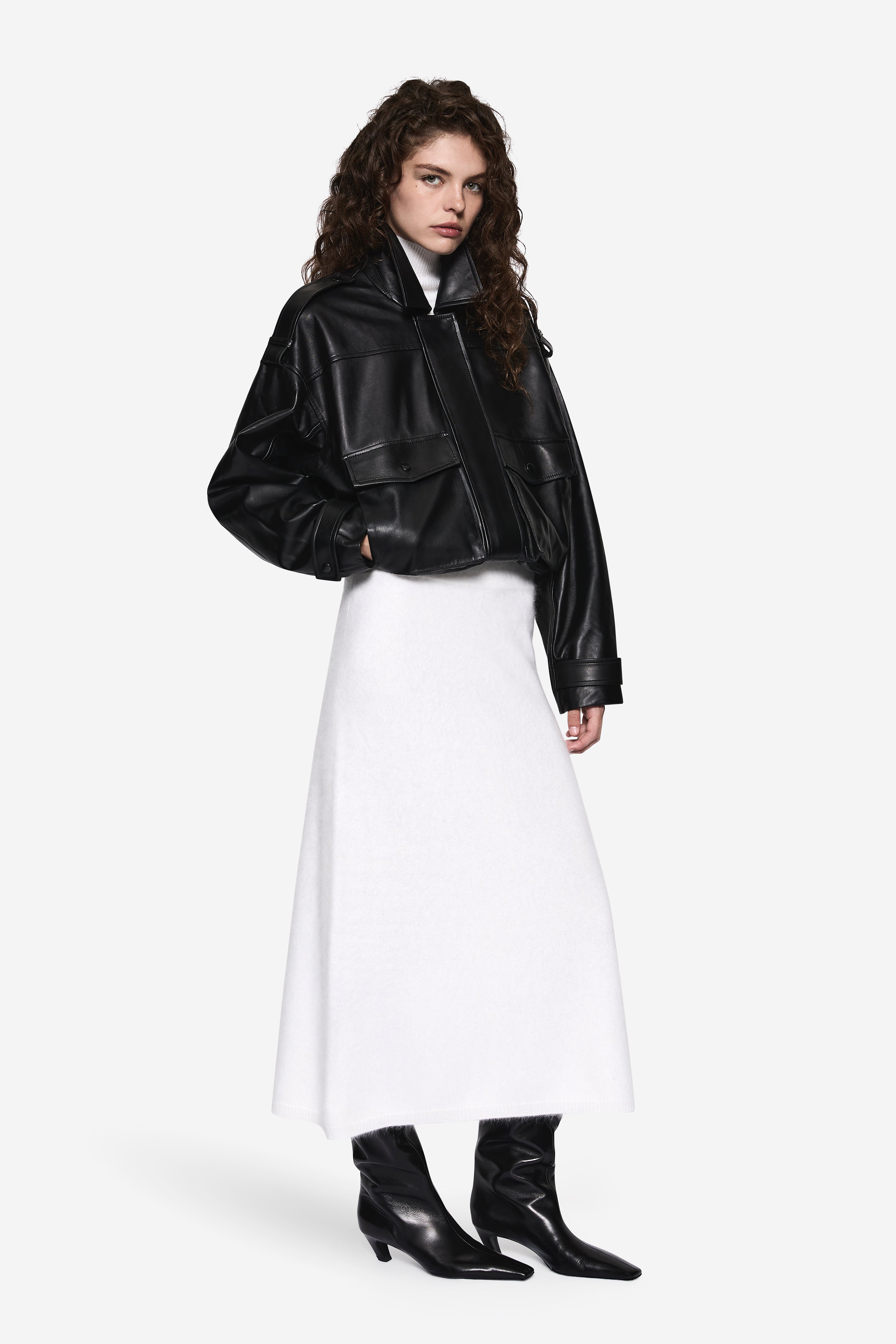 Black balloon leather jacket side view with zip front and flap pockets