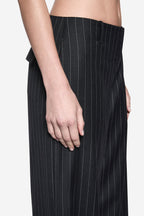 Charcoal pinstripe wool pants detail at waistband and front hand pocket
