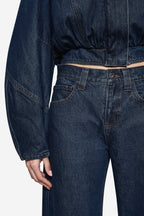 Vintage blue denim jeans with side seam pockets and belt loops, close-up