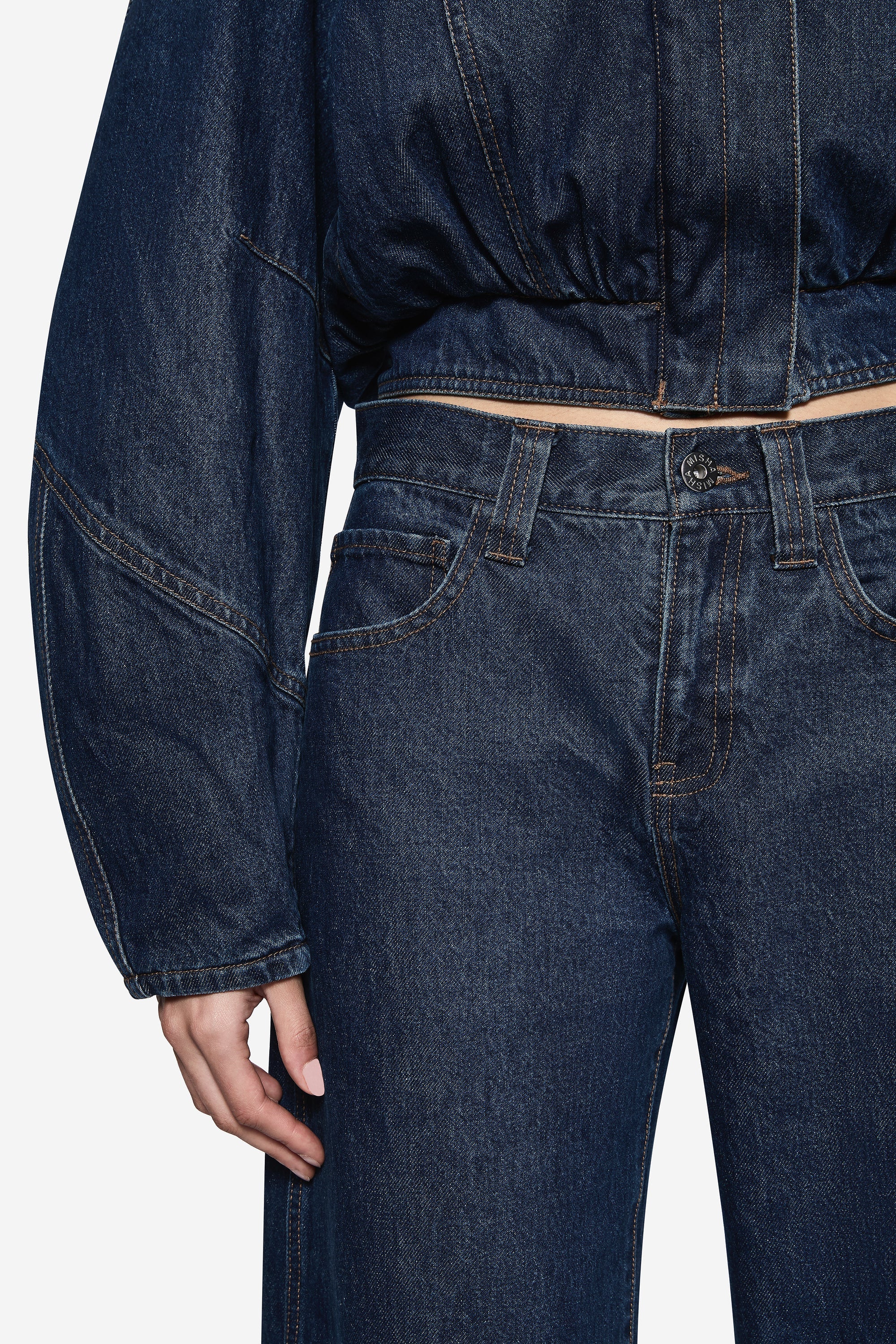 Vintage blue denim jeans with side seam pockets and belt loops, close-up