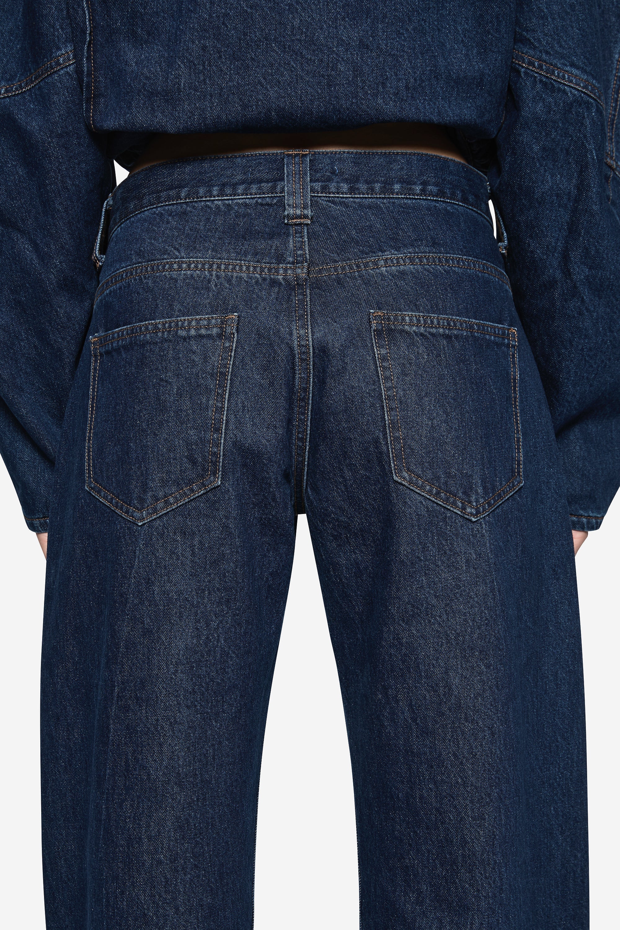 Vintage blue denim jeans back with yoke seam and two rear patch pockets