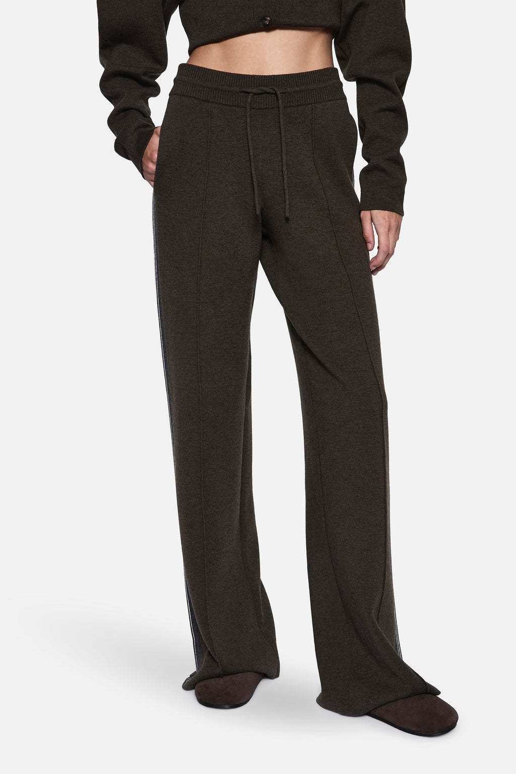 Merino knit pants close-up: dark hunter green elastic waistband and drawstring