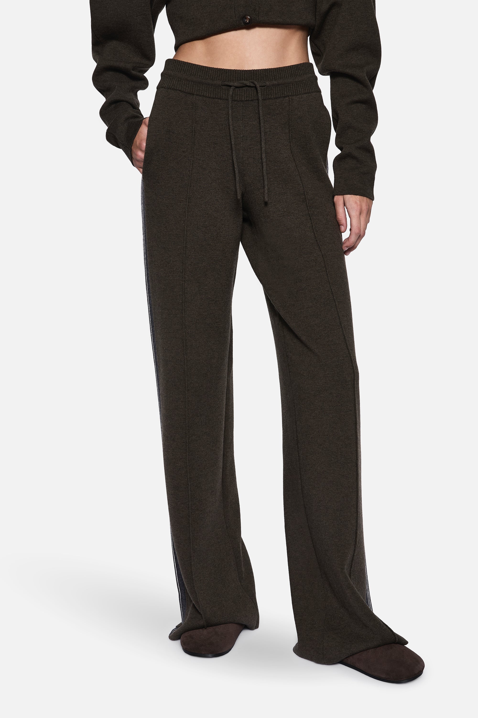 Merino knit pants close-up: dark hunter green elastic waistband and drawstring