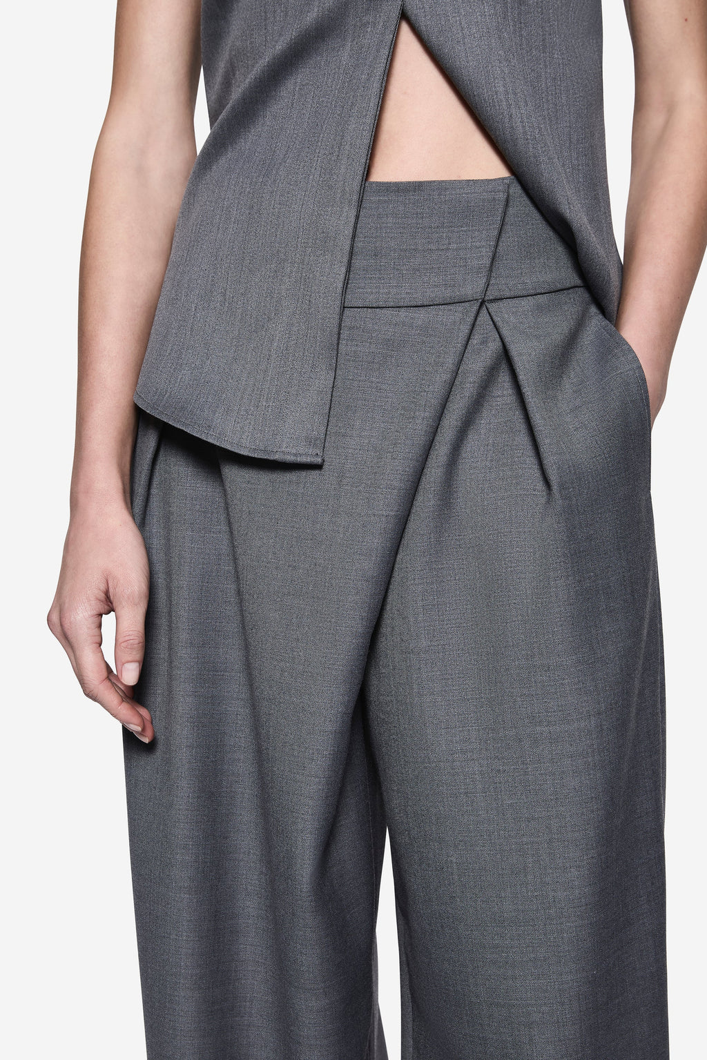 Grey wrap-front suiting pants with pleated drape and wide leg