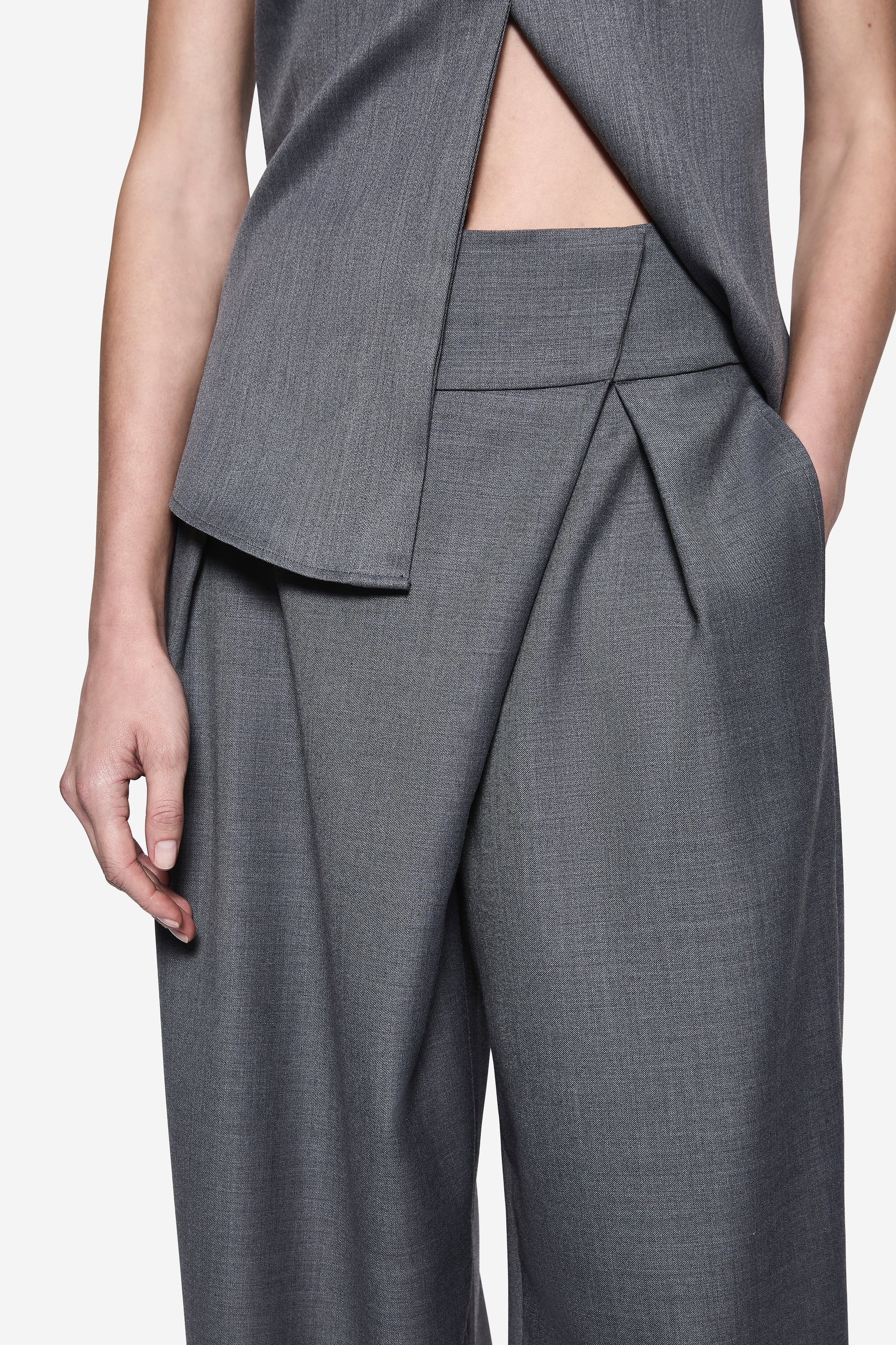 Grey wrap-front suiting pants with pleated drape and wide leg
