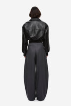 Black leather aviator jacket back view with seam details and zip
