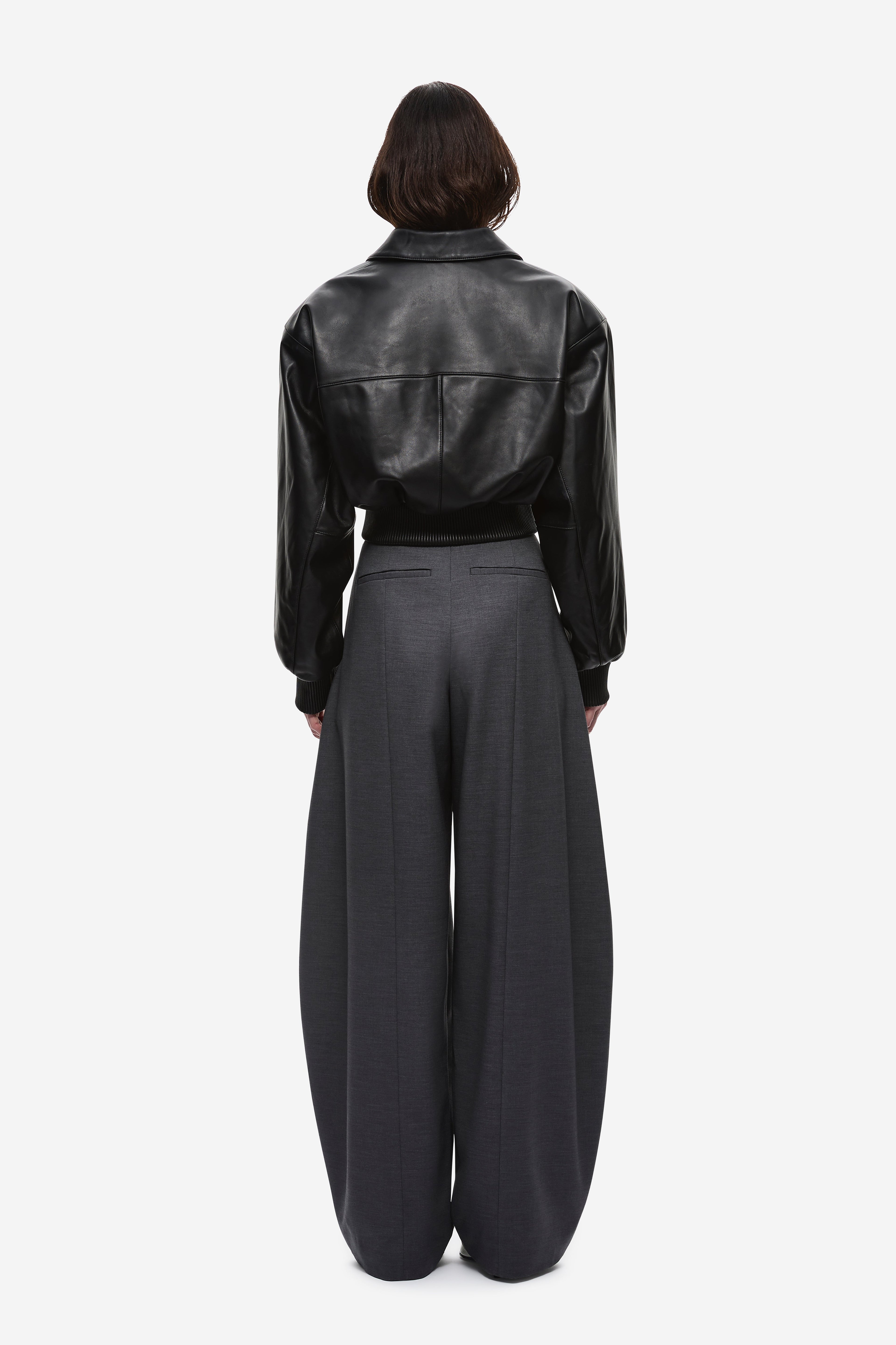 Black leather aviator jacket back view with seam details and zip