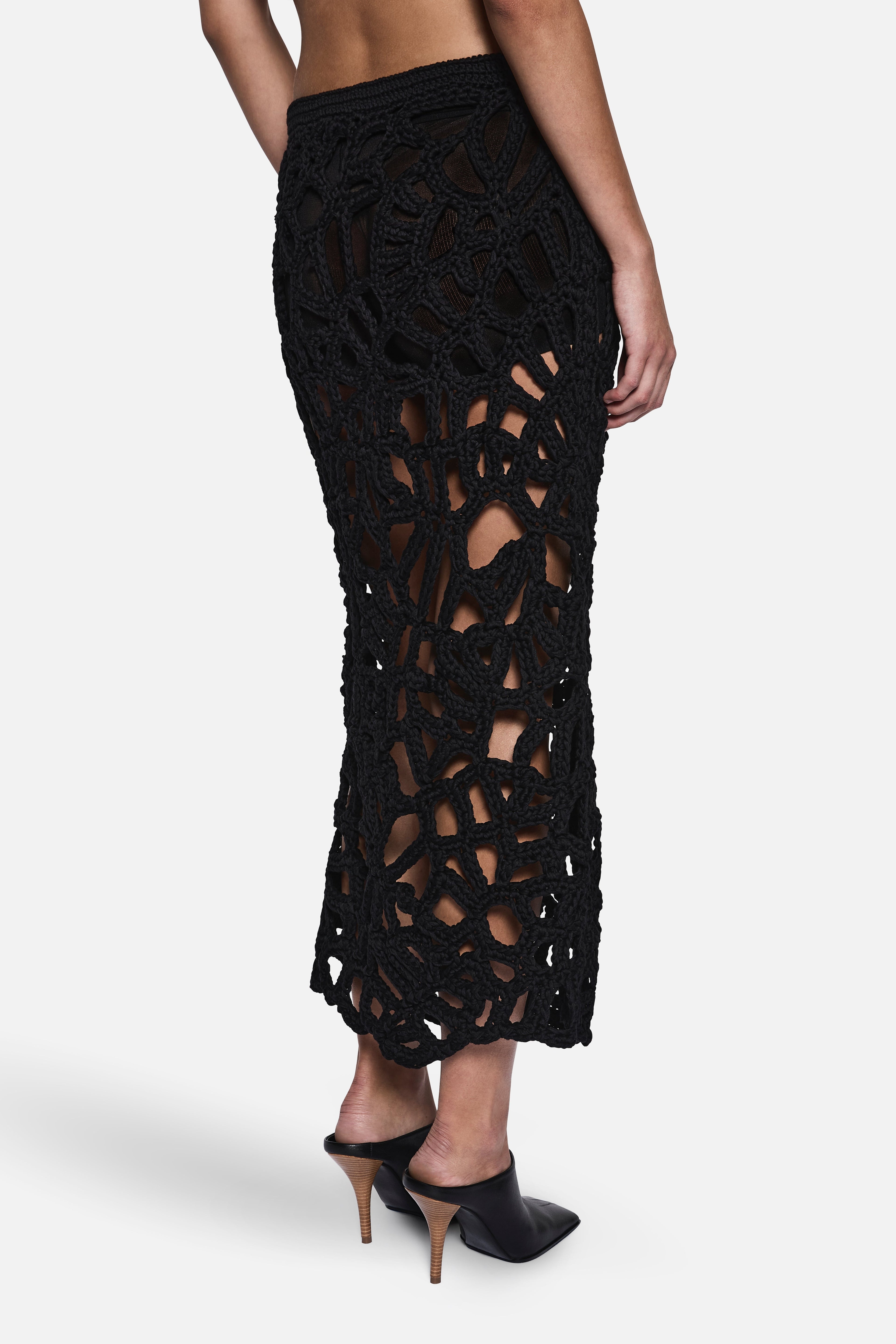 Black crochet midi skirt side detail with dense openwork lattice texture