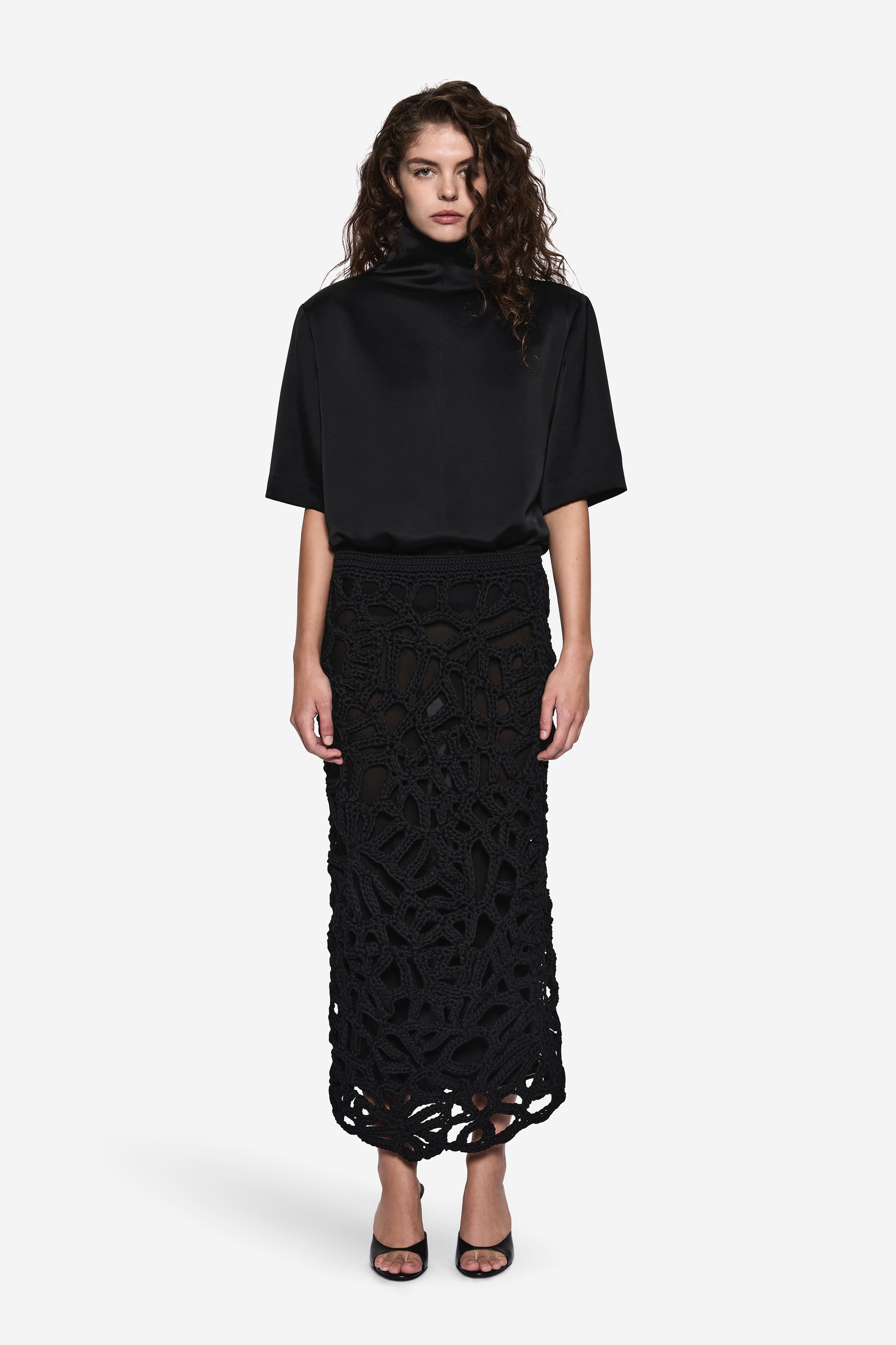 Black crochet midi skirt with allover openwork texture and simple waistband