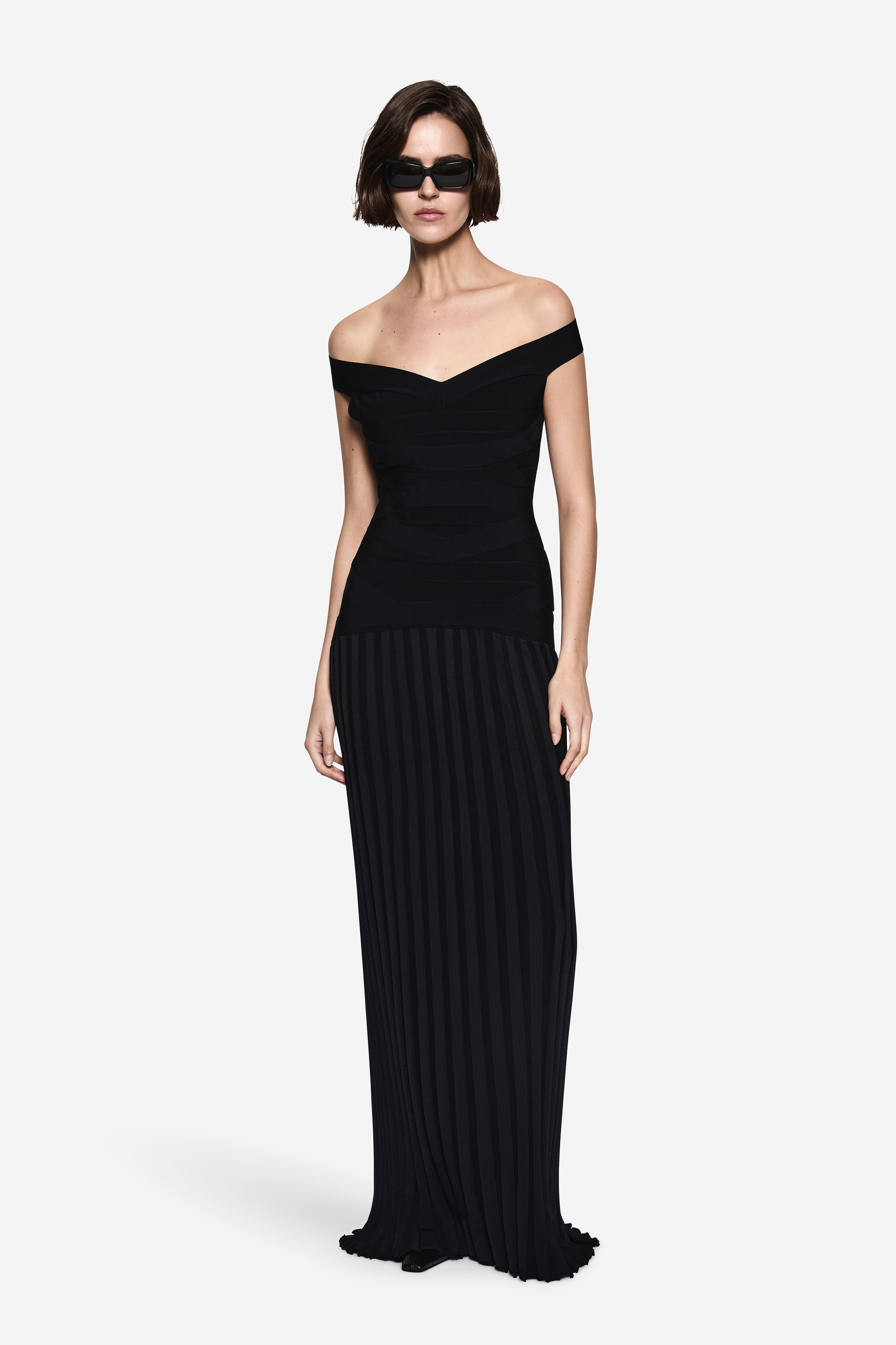 Black off-shoulder bandage knit dress with fitted bodice and ribbed long skirt
