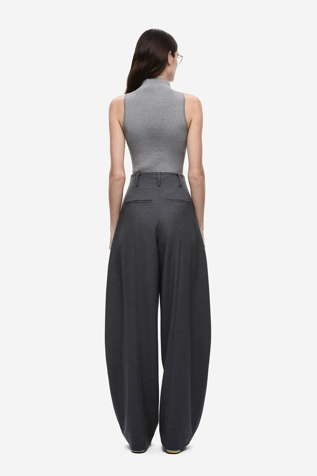 Back view of dark grey high-rise wide-leg pants with pleated waist