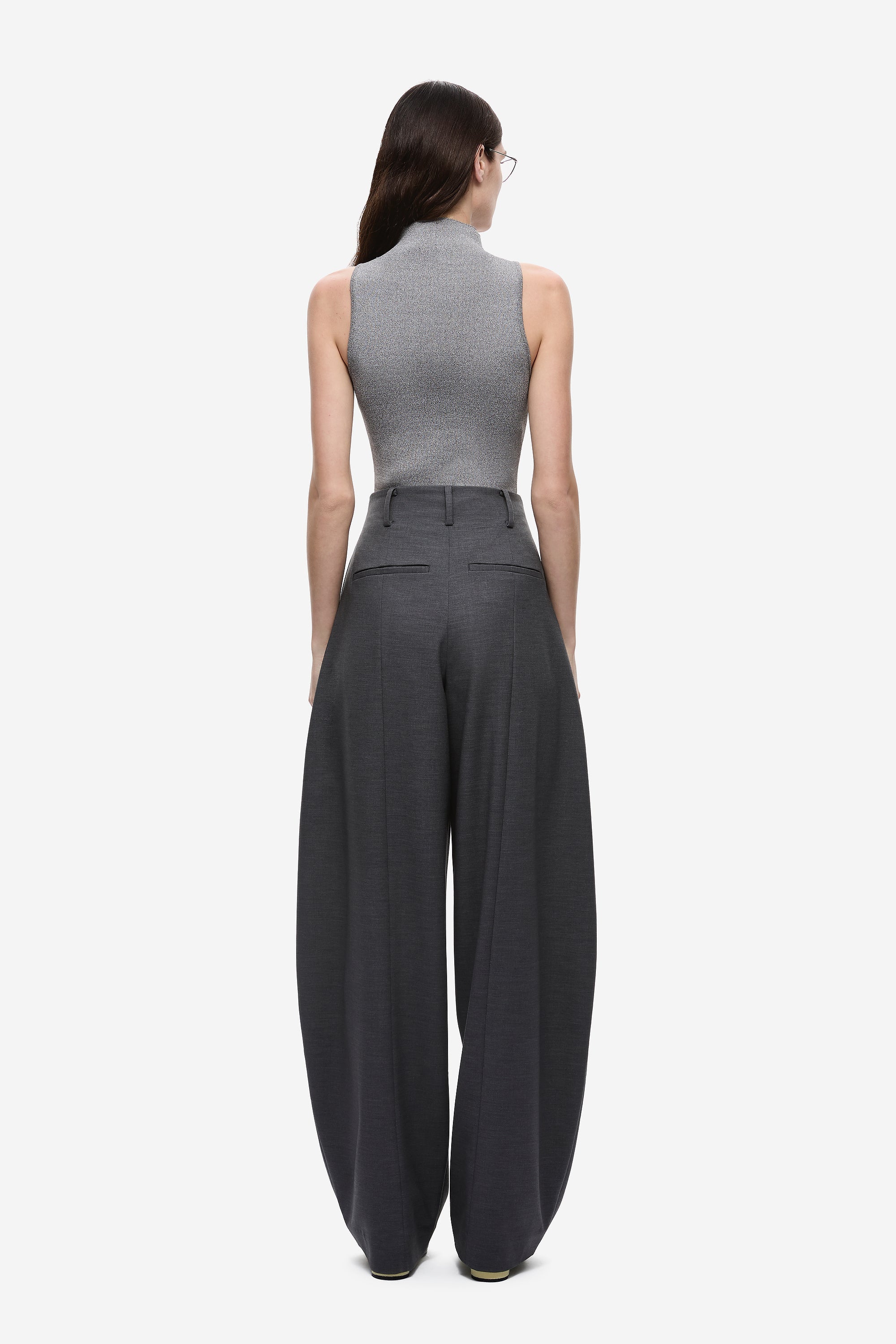 Back view of dark grey high-rise wide-leg pants with pleated waist