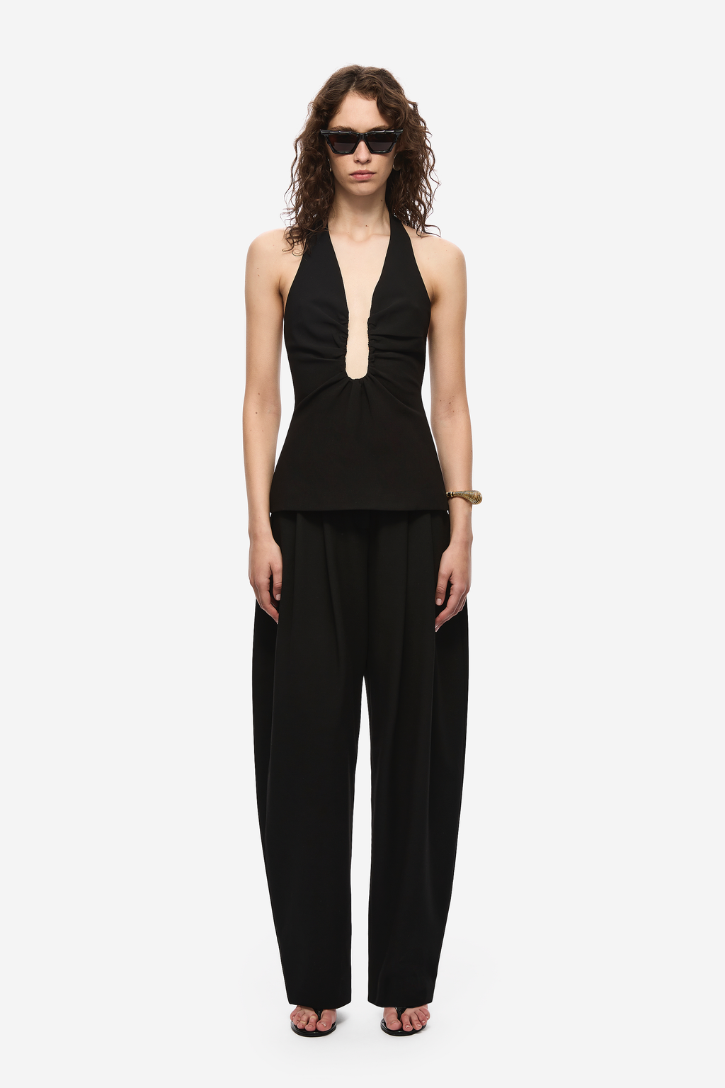 Black halter-neck top with deep keyhole cutout at the chest