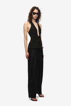 Black sleeveless halter top with keyhole neckline and fitted waist
