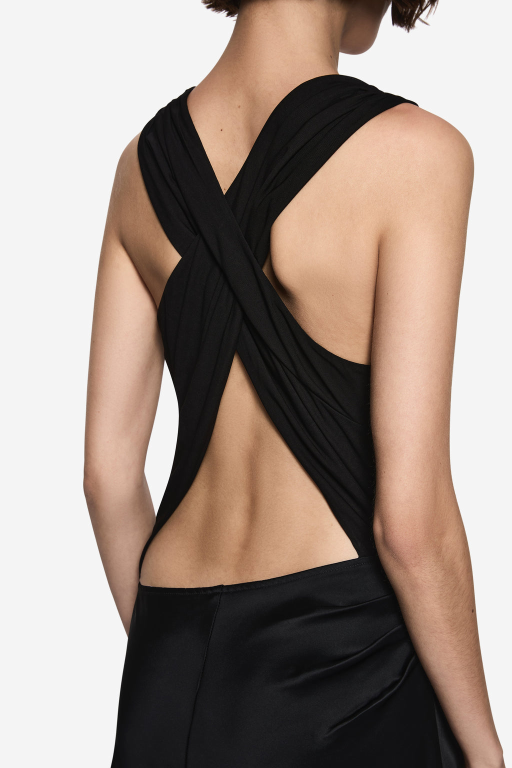 Black halter drape dress close-up with cross-back strap and open back