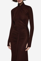 Dark brown jersey maxi dress with high neck, gathered twist front, and long sleeves