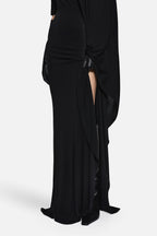 Black jersey maxi dress with ruched drape, side slit, and layered skirt detail