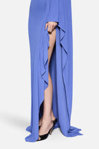 Blue jersey maxi dress with draped panel, leg slit, and flowing side pleats