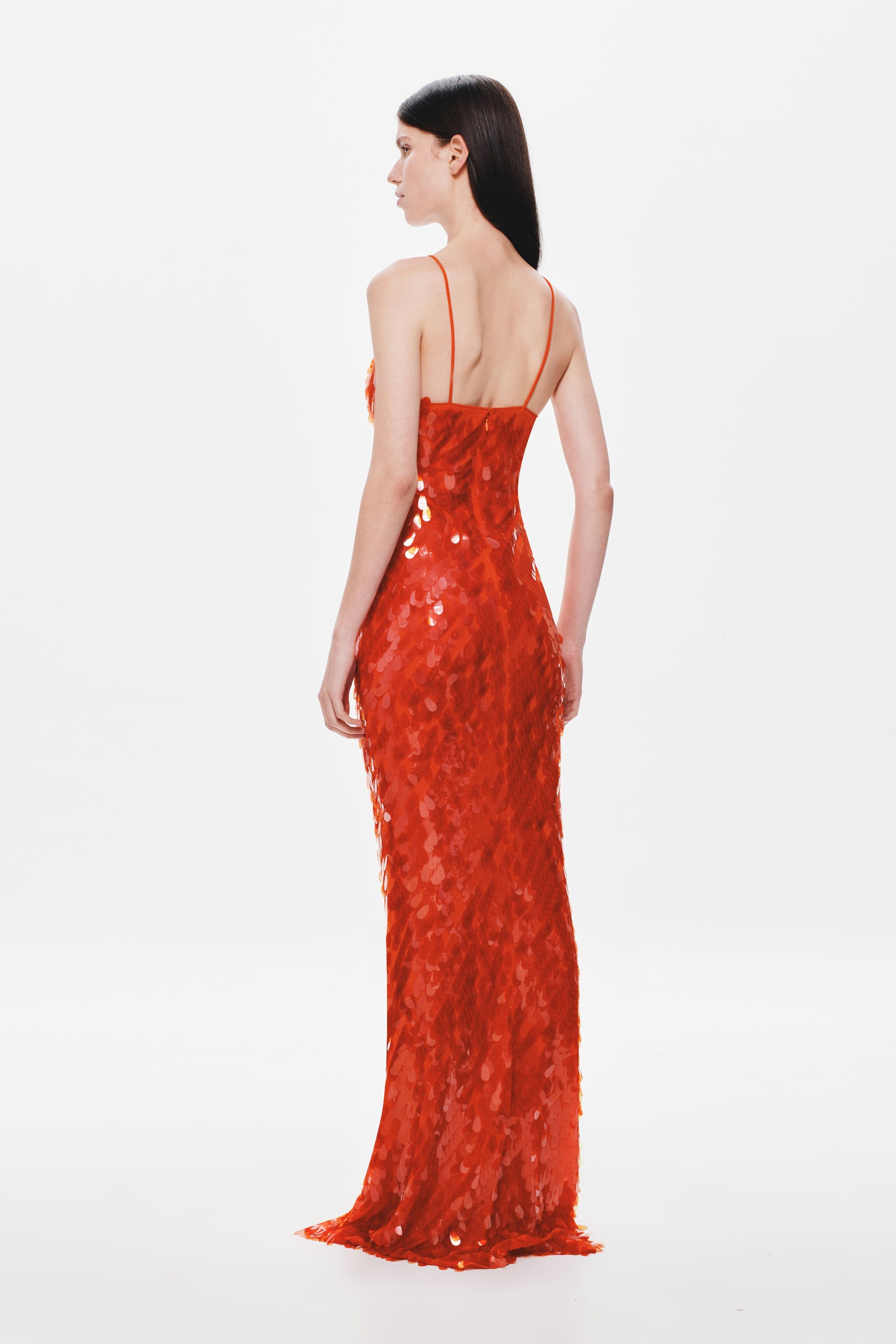 Red sequin maxi dress with strappy open-back detail, fitted column silhouette