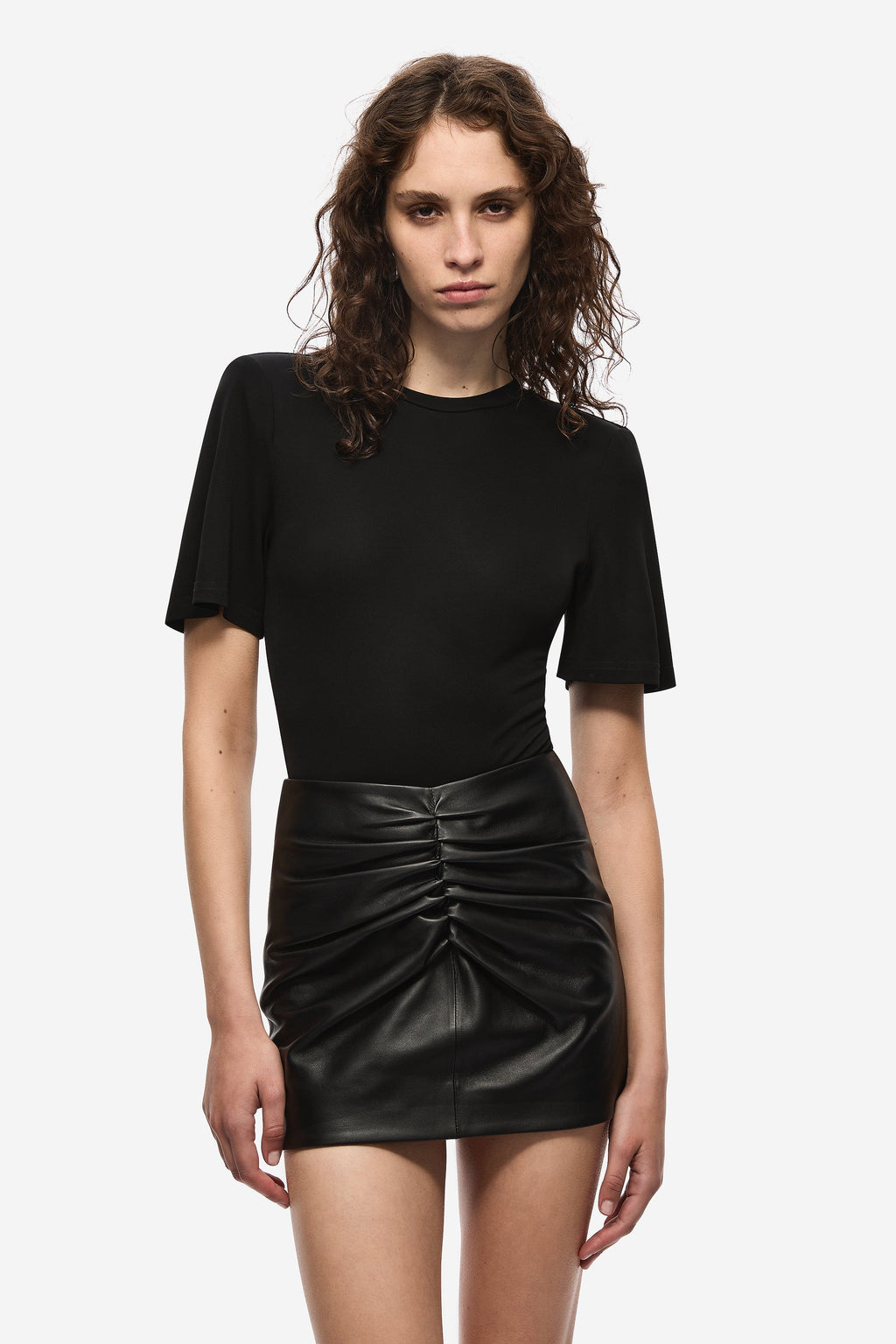 Black ruched leather mini skirt, front gathers at waist, fitted silhouette