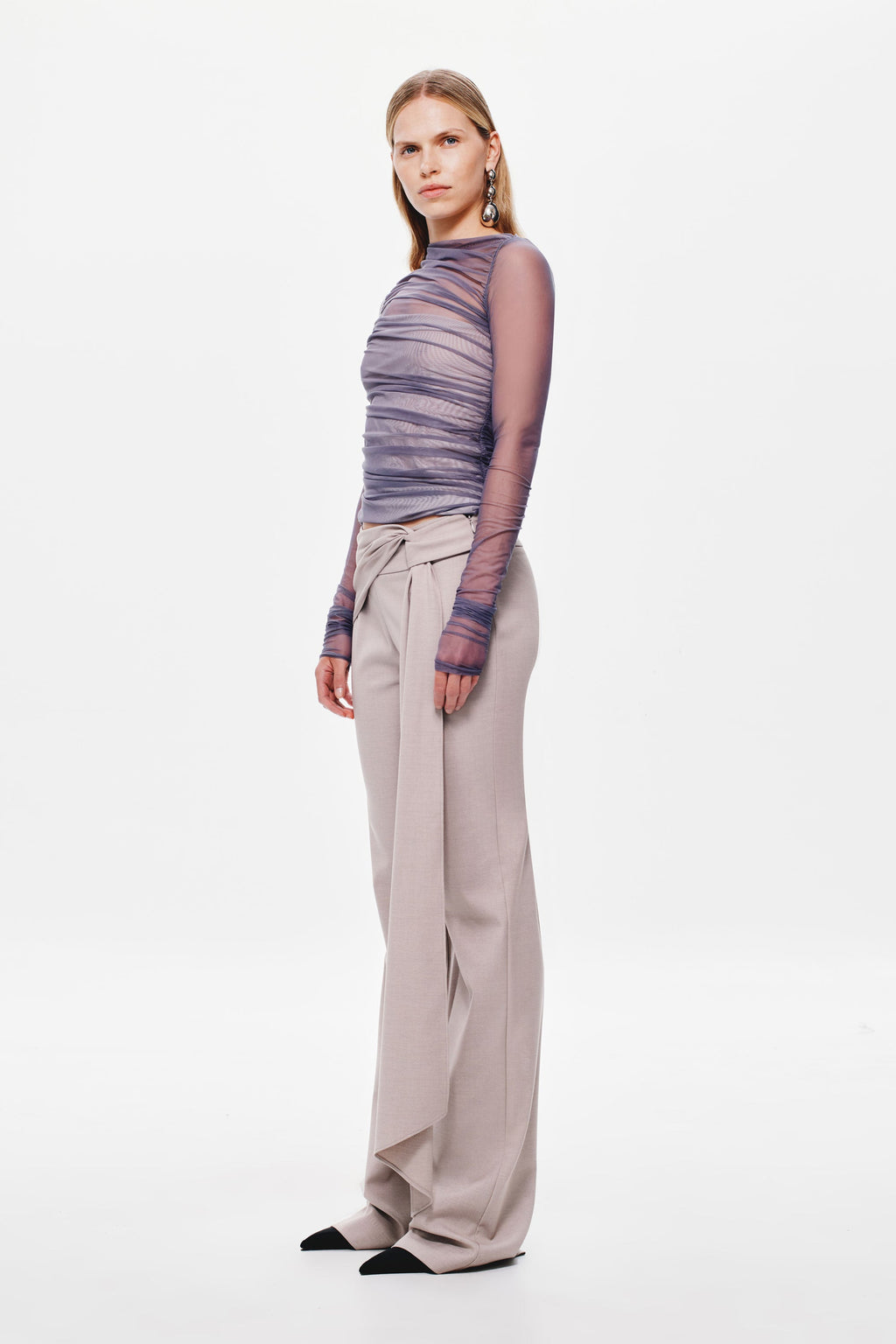 Stone wide-leg suiting pants with side drape waist tie, full-length side view.