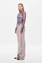 Stone wide-leg suiting pants with side drape waist tie, full-length side view.
