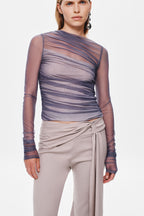 Stone suiting pants close-up: draped waist tie with knot at center front.