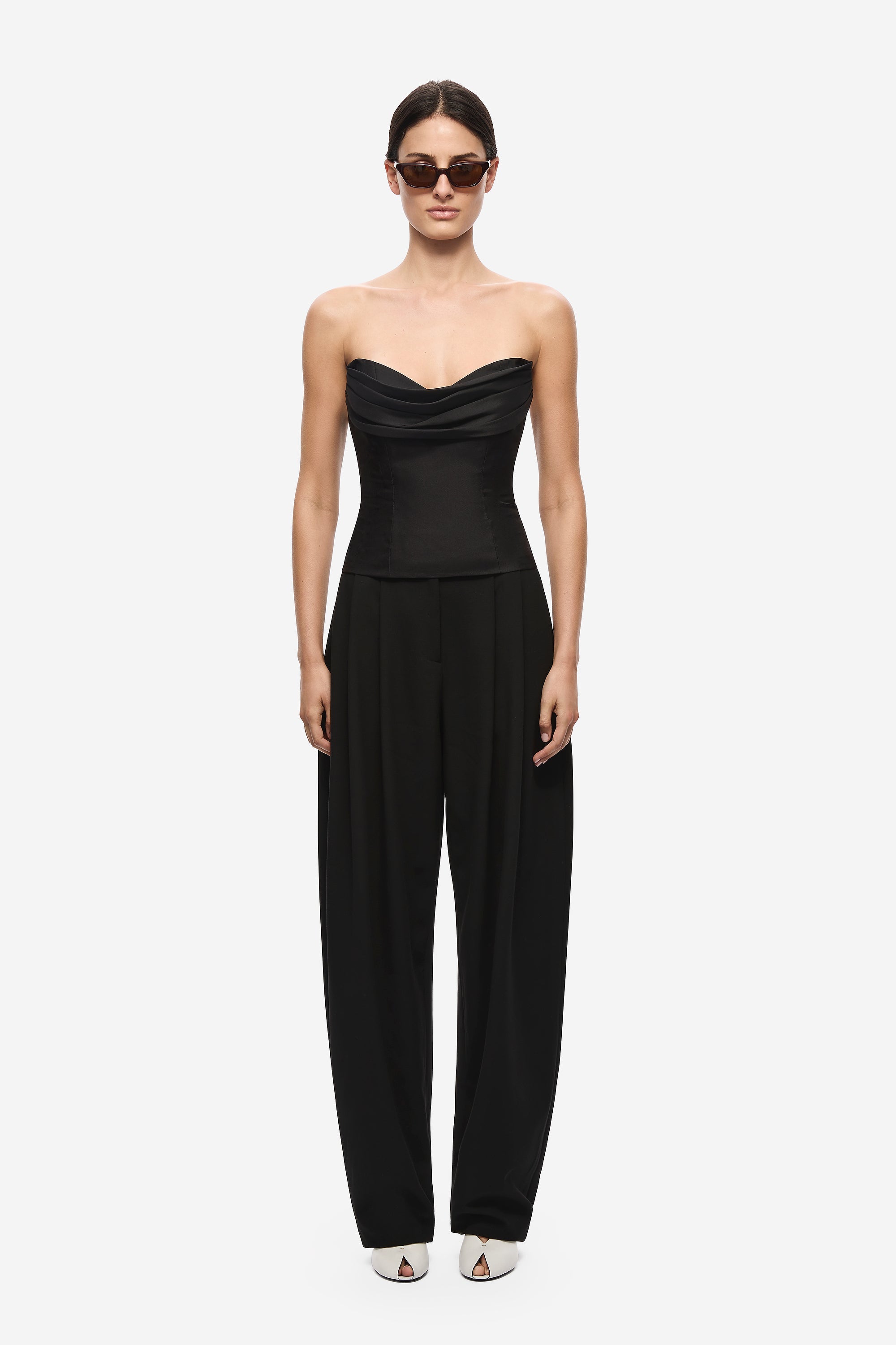 Black strapless silk bustier jumpsuit with wide-leg trousers and draped bust