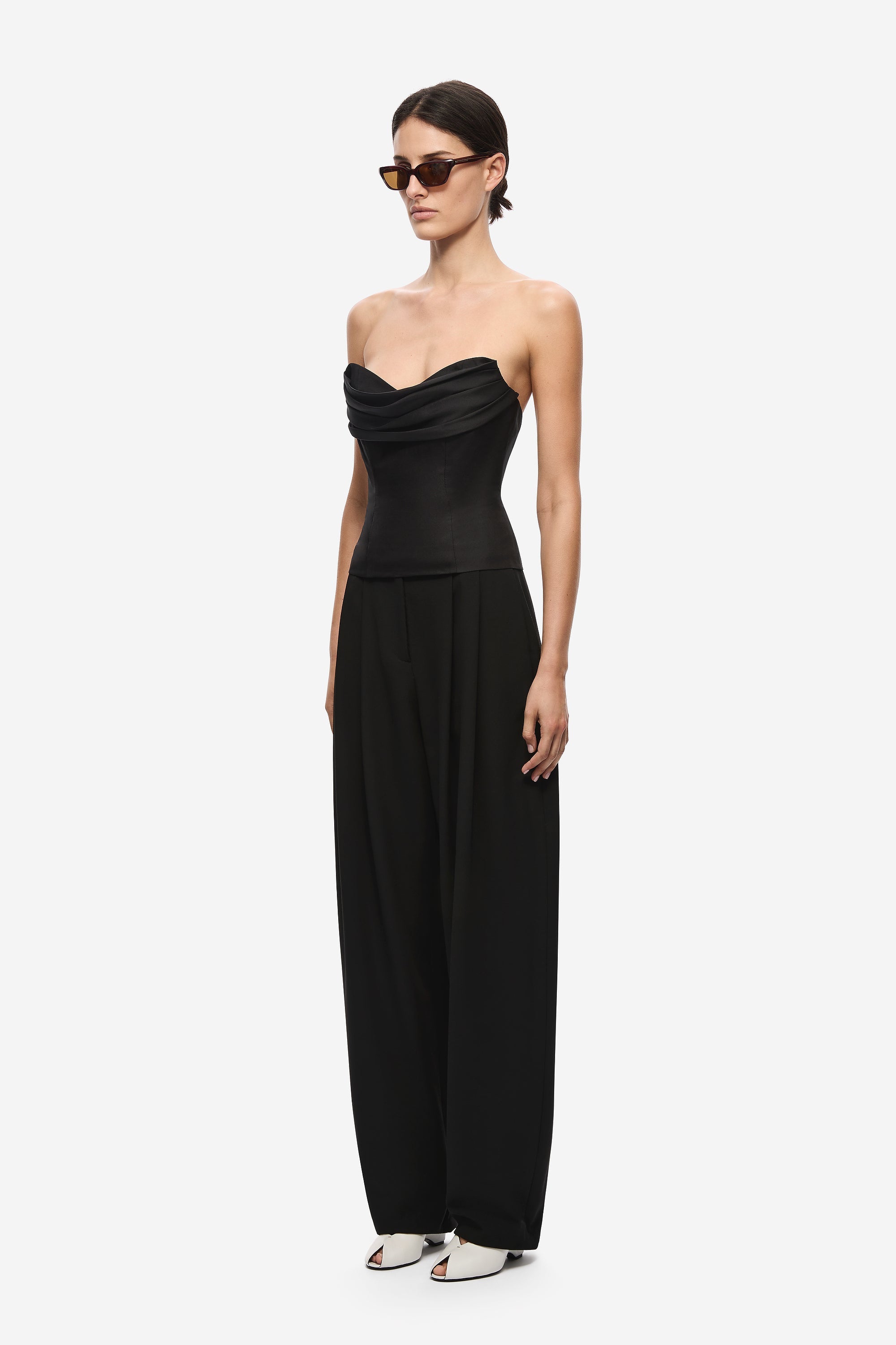 Black strapless silk bustier jumpsuit side view with draped bust and wide legs