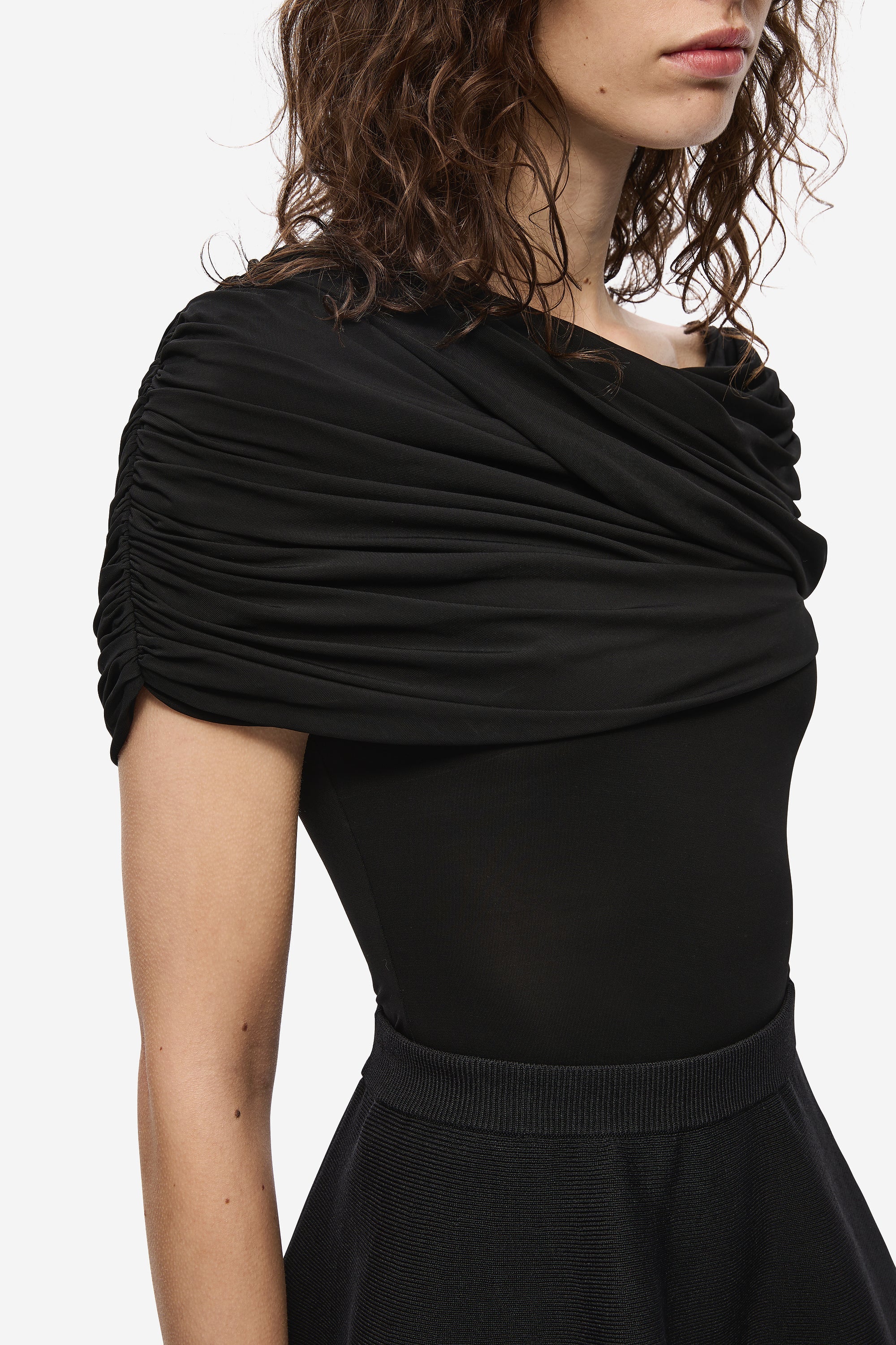 Black jersey top with draped cowl neckline and short sleeves