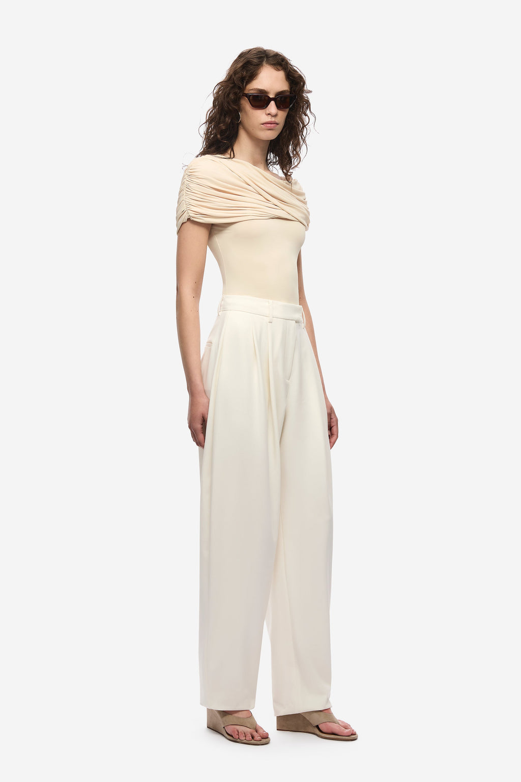 Pearled ivory off-shoulder cowl jersey top with short sleeves and relaxed fit, side profile.