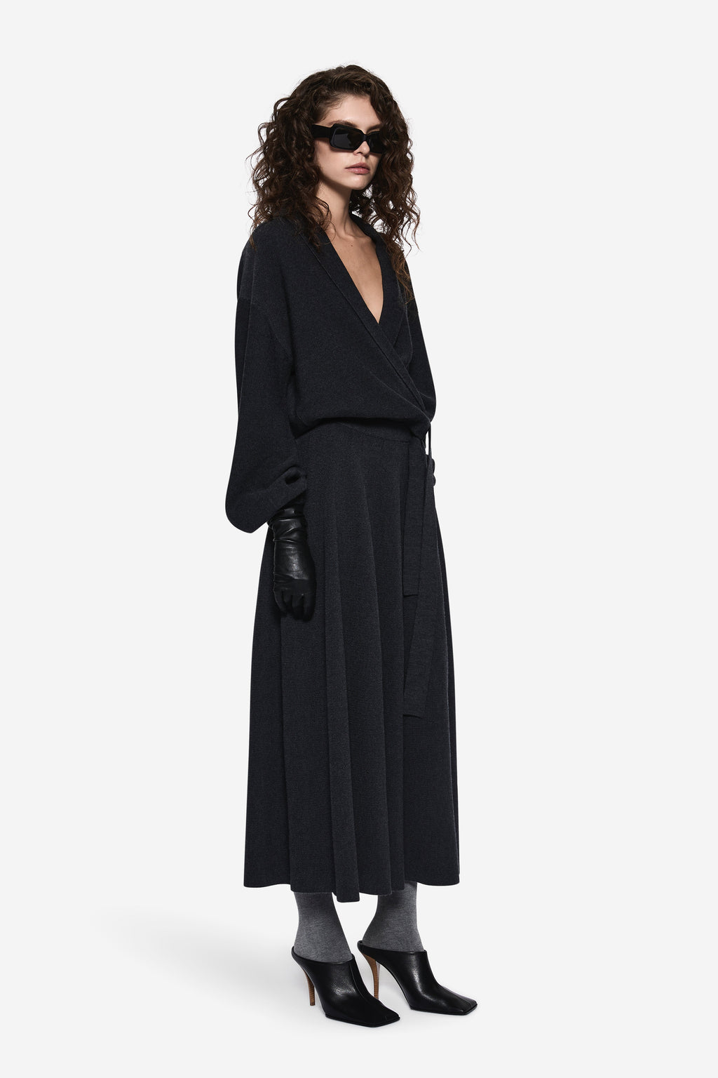 Dark charcoal wrap cardigan with V-neck and tied waist, shown from a side angle.
