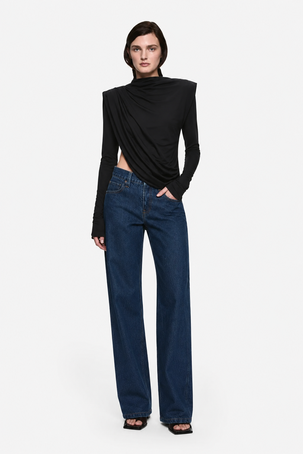 Black draped jersey top with cowl neckline, long sleeves, asymmetrical wrap front