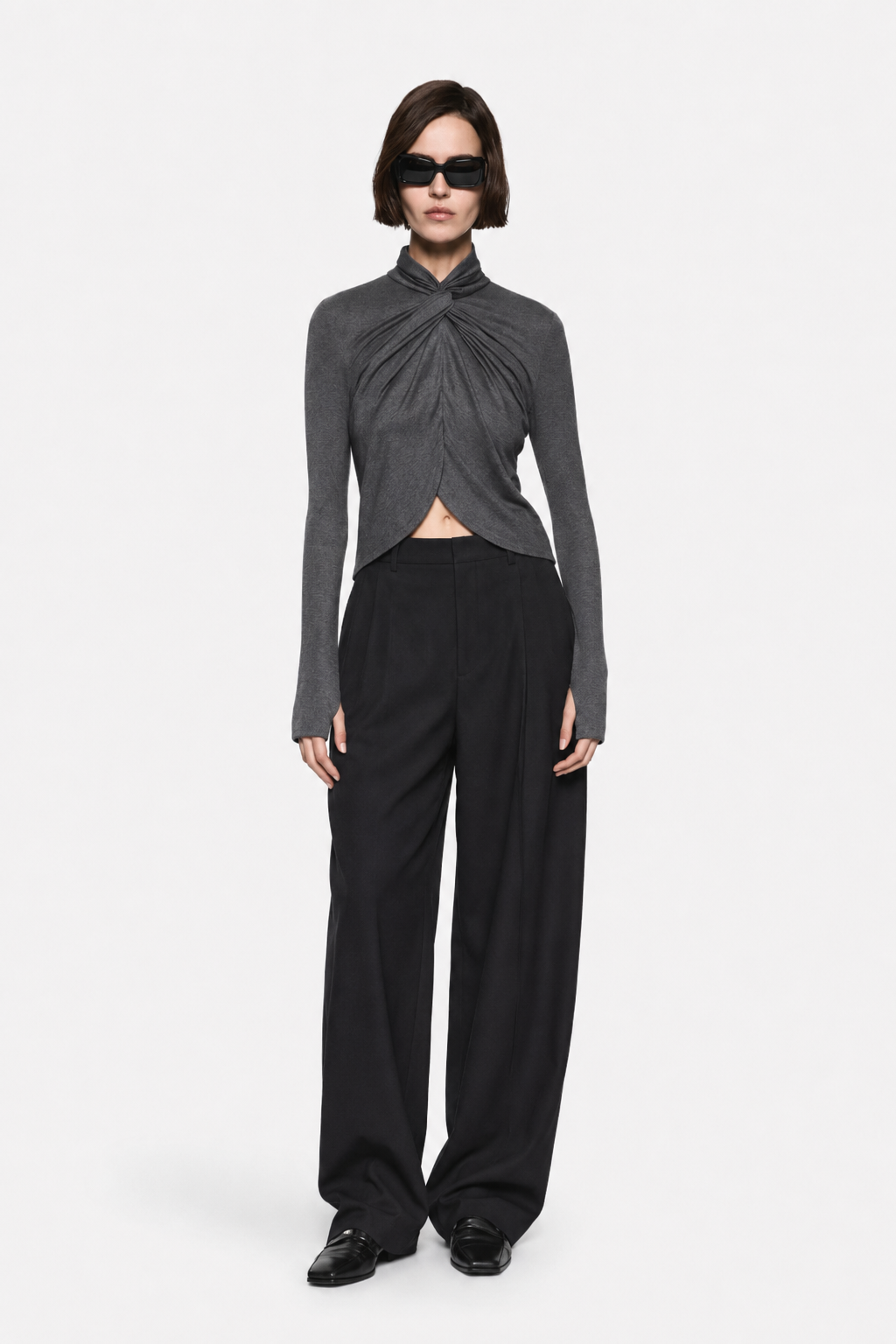 Dark charcoal TENCEL long-sleeve twist top with draped neckline and asymmetrical hem.