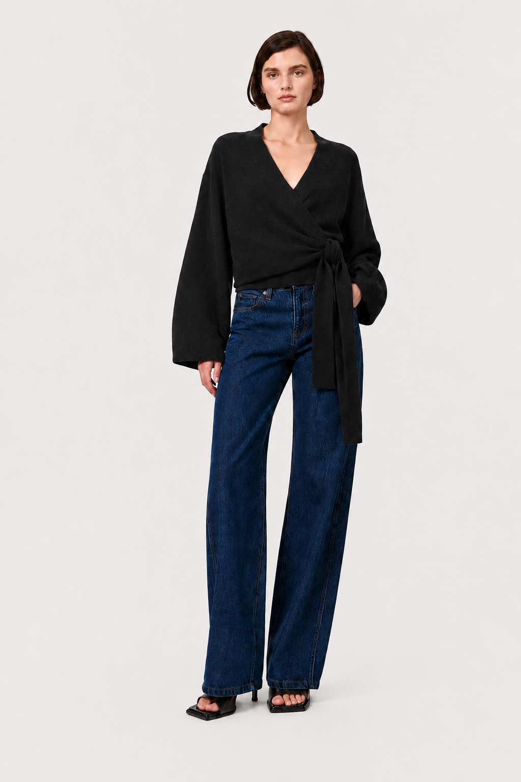 Dark charcoal wrap cardigan with V-neck, long sleeves, and tied waist belt.